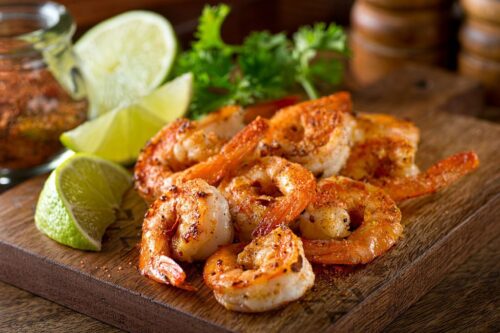 Delicious sauteed shrimp with cajun seasoning and lime on a maple plank. KERALI RESTAURANT & BAR